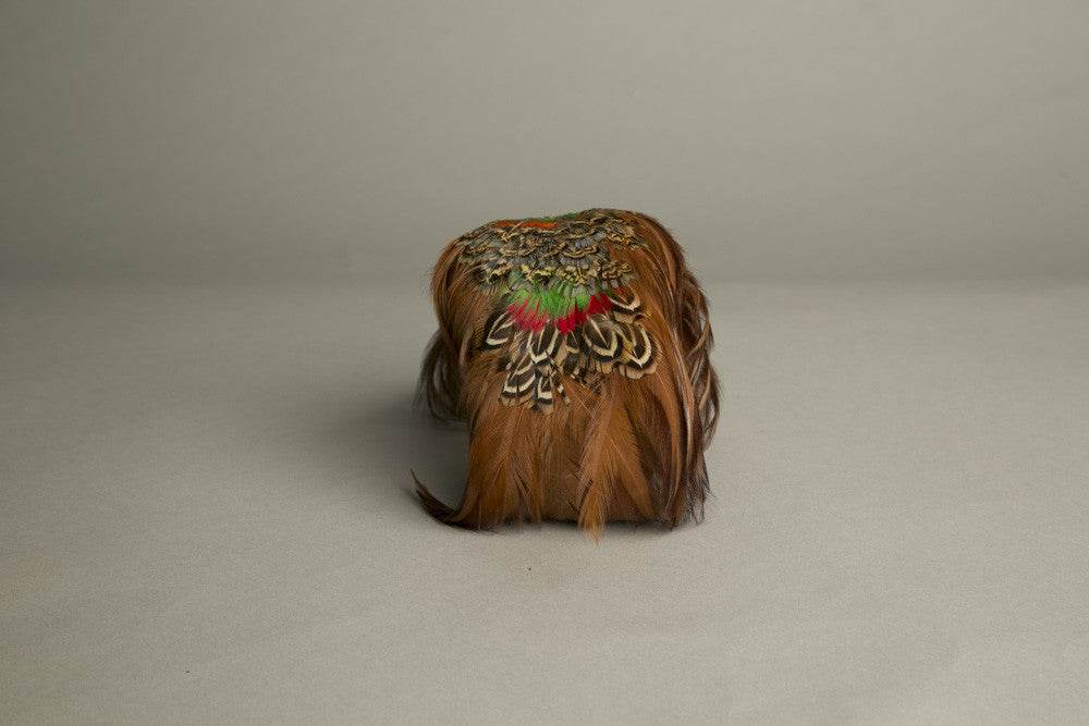 Vintage 1970s feathered toque hat in orange, green, and brown.
