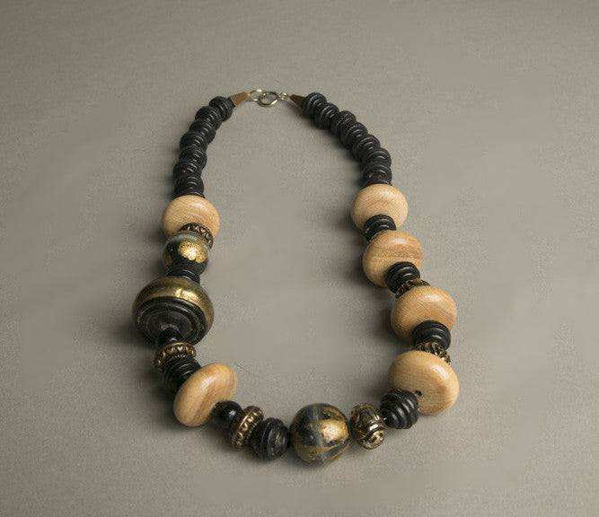 Ethnic tribal chic necklace with golden, black, and wooden beads.