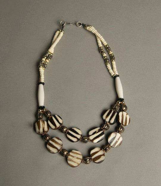 Ethnic beaded necklace with ivory, brown, silver, and golden beads, vintage tribal jewelry.