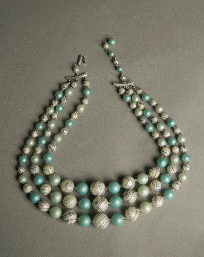 Vintage plastic jewelry necklace with teal, silver-blue beads, three strands, adjustable, 1960s Japan.