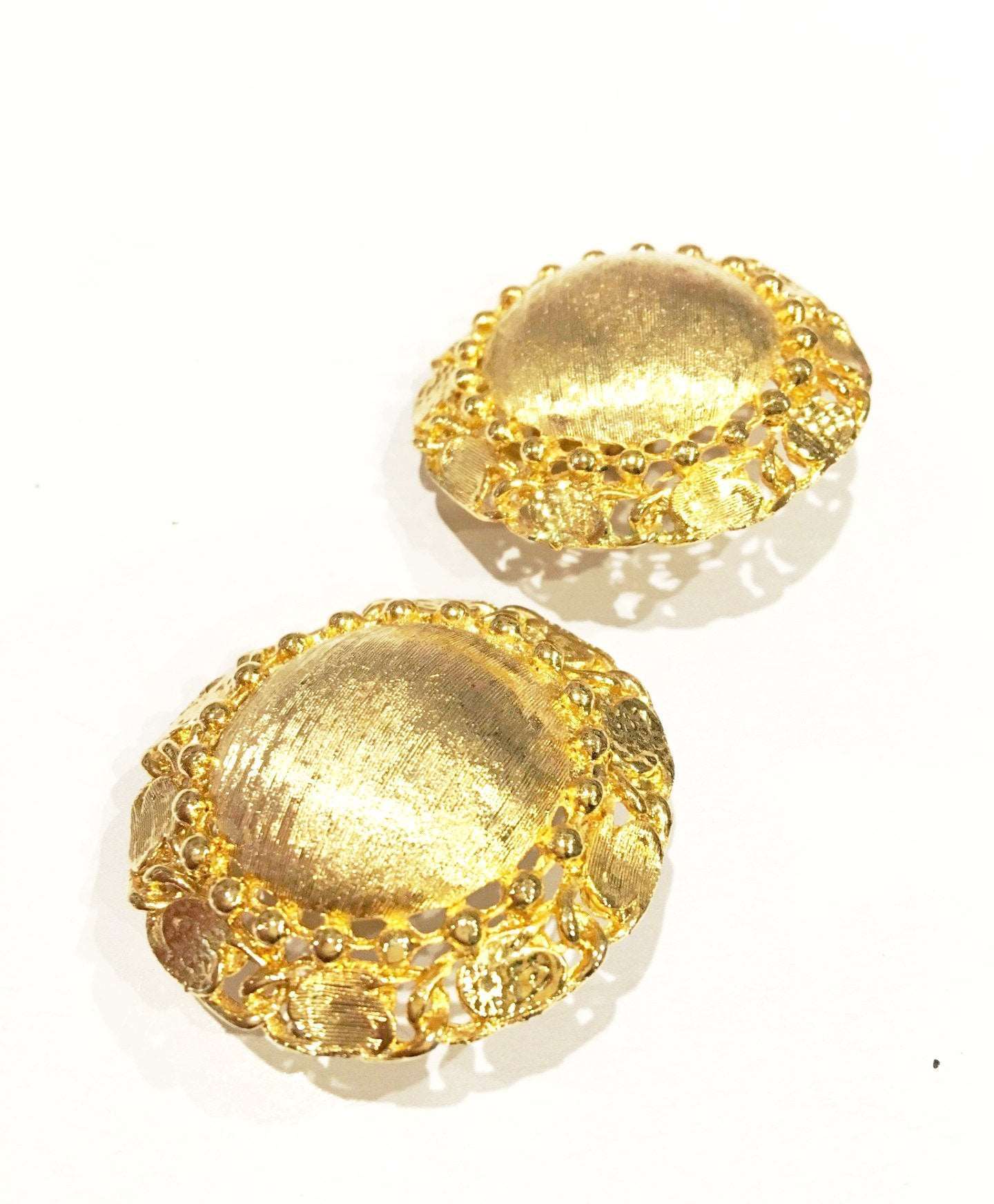 Brushed golden clip on earrings, vintage jewelry from 1980s-90s, with textured design.