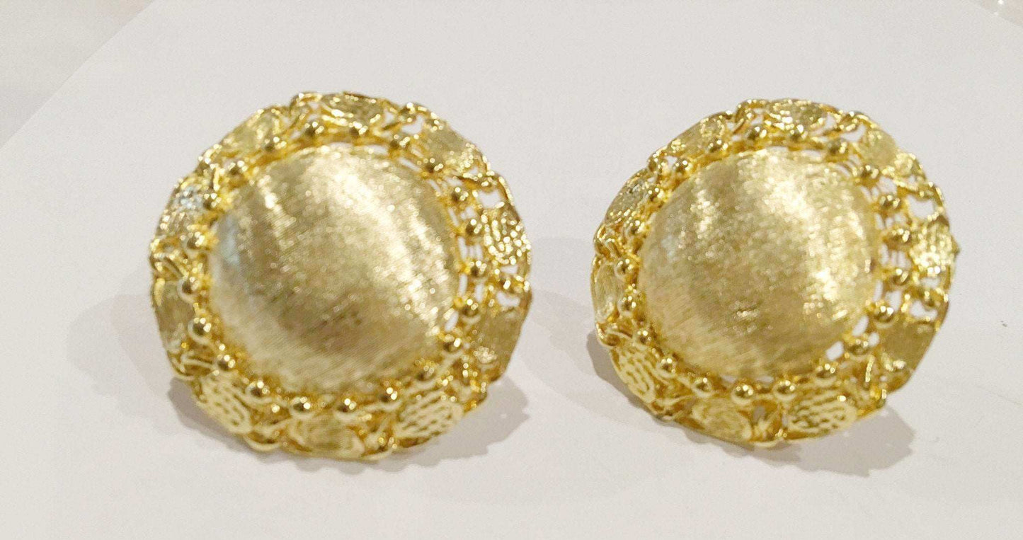 Brushed golden clip-on earrings with vintage design and textured finish.