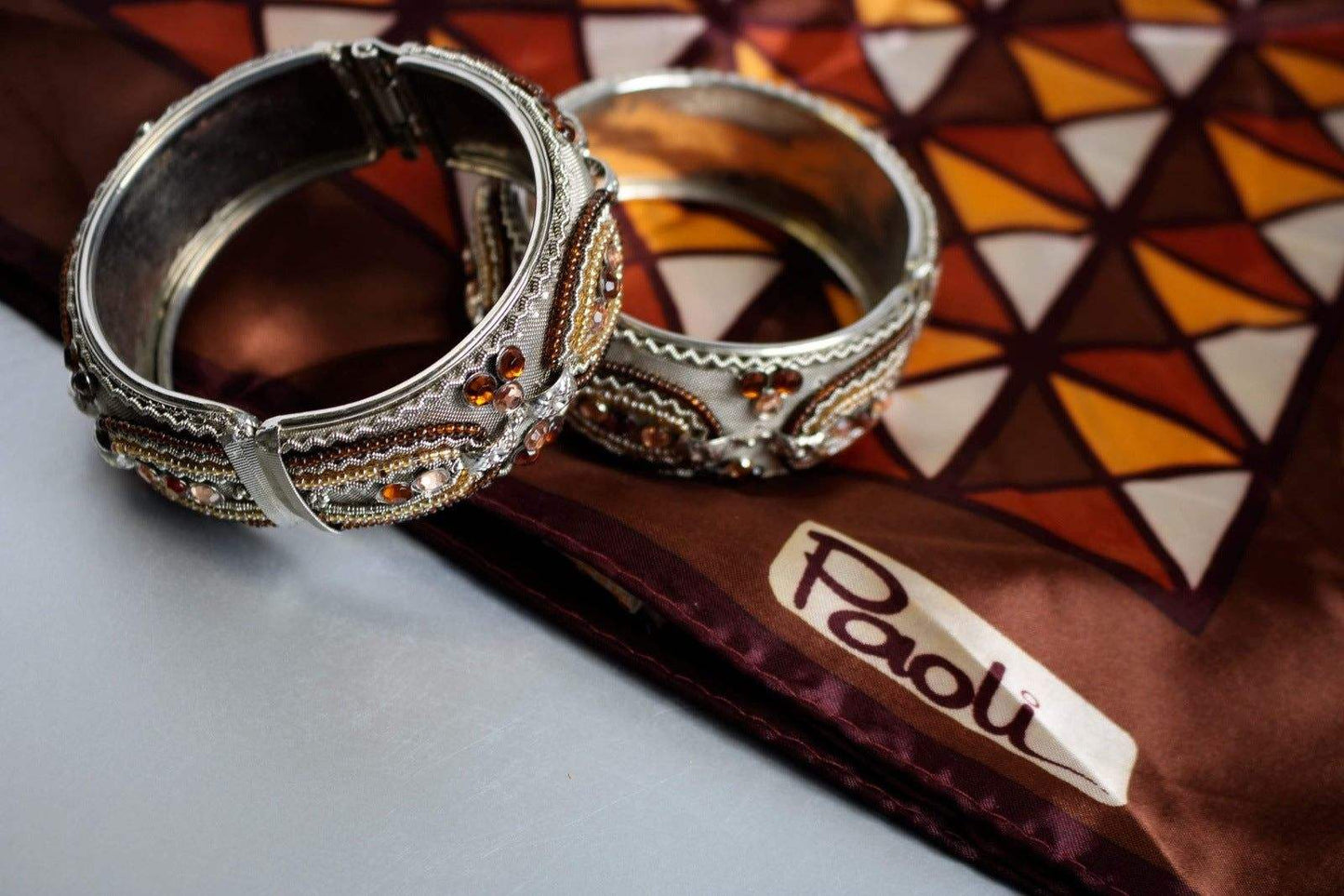 Set of 2 vintage hinged bangle bracelets with metallic beading in silver and gold tones.