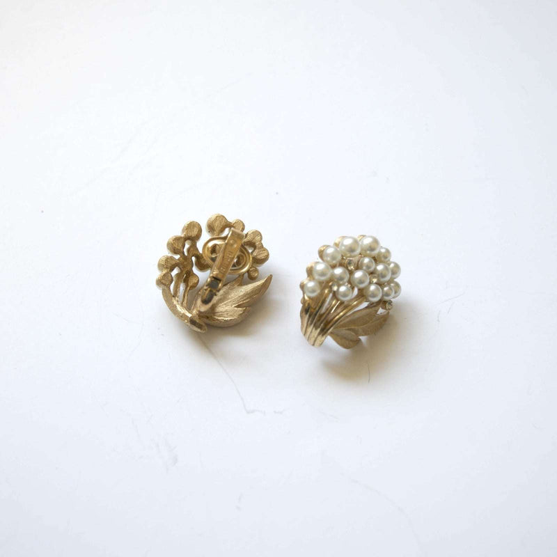 Vintage Trifari floral clip-on earrings with pearls and rhinestones.