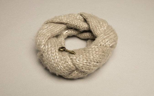Fossil Winter Scarf featuring a cozy knit design with a skeleton key pendant.