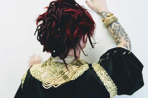 Ethnic bib necklace with wooden seed beads and brass detail, vintage style.