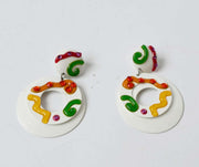 White colorful clip-on earrings with pink, yellow, orange, and green swirls on enameled tin metal, vintage 1960s-70s.