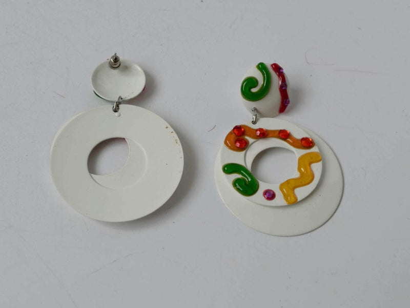 White colorful clip on earrings with pink, yellow, orange, and green swirls on white enamel, vintage 1960s-70s.