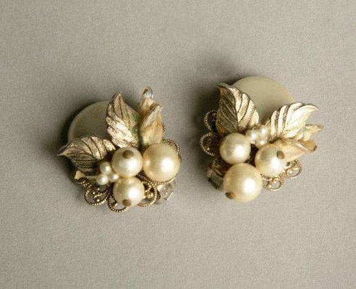 Vintage floral pearl clip-on earrings with intricate filigree base, 1950s design.