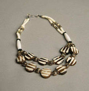 Ethnic beaded necklace with ivory, brown, silver, and golden beads, vintage tribal jewelry.