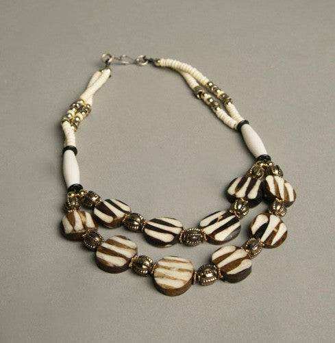 Ethnic beaded necklace with ivory, brown, silver, and golden beads, vintage tribal jewelry.