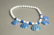 Vintage Avon necklace with figural sea shell pendant and plastic beads, circa 1987.