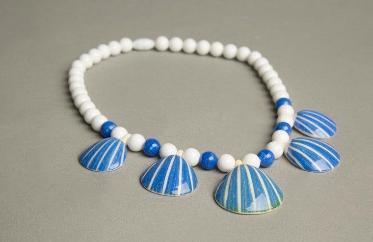 Vintage Avon necklace with figural sea shell pendant and plastic beads, circa 1987.