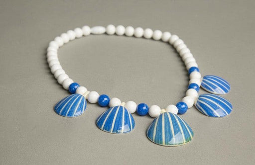 Vintage Avon necklace with figural sea shell pendant and plastic beads, circa 1987.