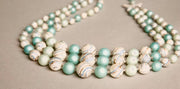Vintage plastic necklace with teal and silver swirled beads, Japan-made.