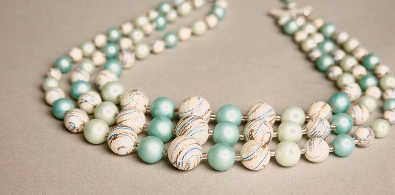 Vintage plastic necklace with teal and silver swirled beads, Japan-made.