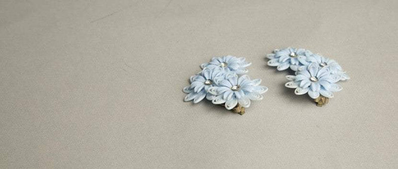 Flower Child Fabulous vintage clip-on earrings with cut plastic flowers and rhinestone centers.