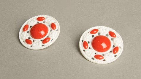 Retro red and white clip-on earrings with carved plastic design, vintage 1950s-60s.