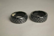 Set of 2 gray black resin bangles with domed psychedelic design and iridescent sparkles.