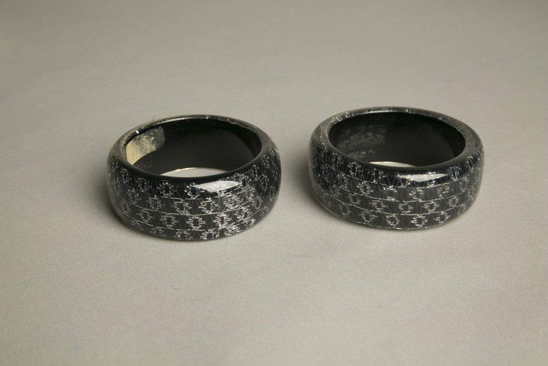 Set of 2 gray black resin bangles with domed psychedelic design and iridescent sparkles.