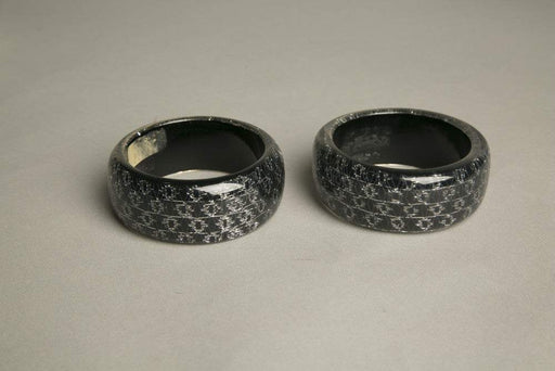 Set of 2 gray black resin bangles with domed psychedelic design and iridescent sparkles.