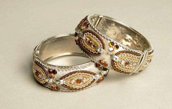 Set of 2 vintage hinged bangles with metallic beading in silver and gold tones.