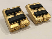 Modernist clip-on earrings in golden hammered metal with black beads, vintage 1980s-90s design.