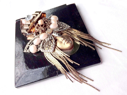 Rare compact mirror with ornate 3D face design, embellished with golden, silver, and pearl beads.