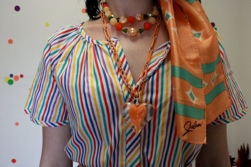 Vintage plastic jewelry link chain necklace with large heart pendant.