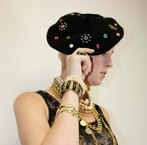 Golden chain link bracelet, vintage 1980s jewelry, worn on woman's wrist.